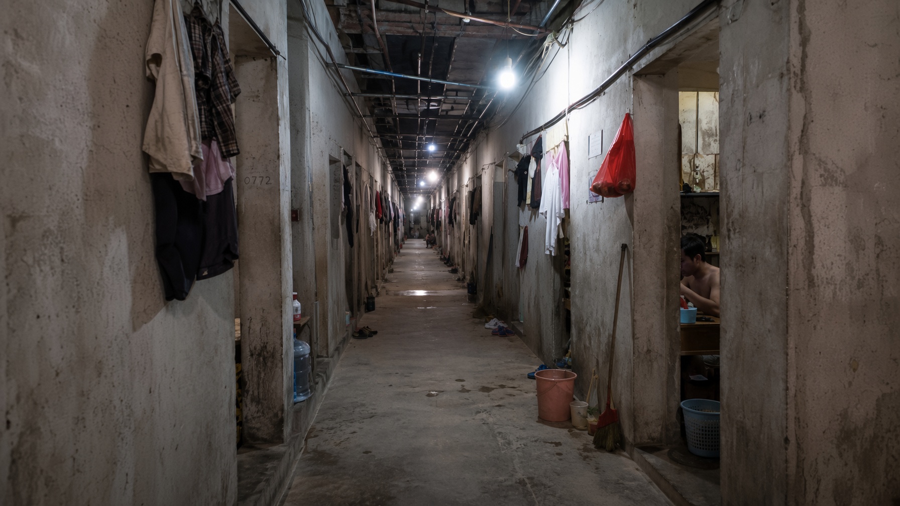 A dormitory corridor at night — dispatch labour housed on site.