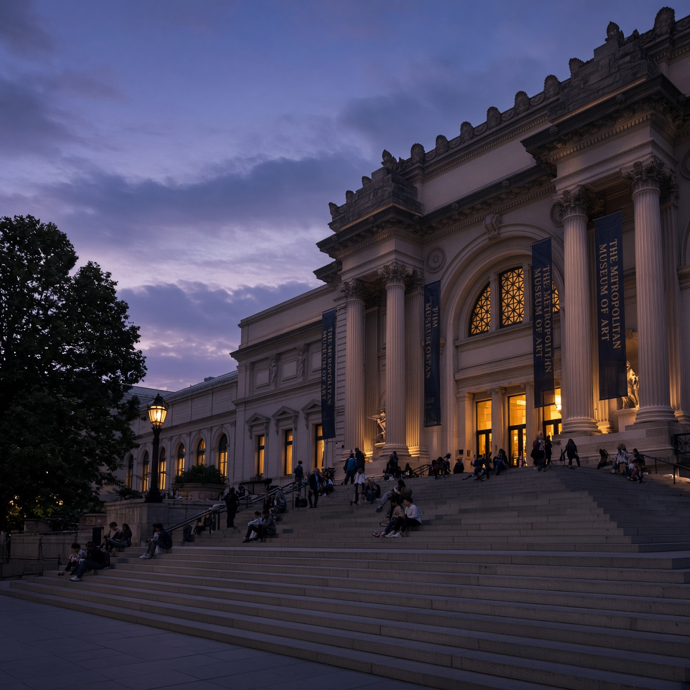 The Metropolitan Museum's Fifth Avenue steps at dusk, banners lit, visitors scattered across the stone